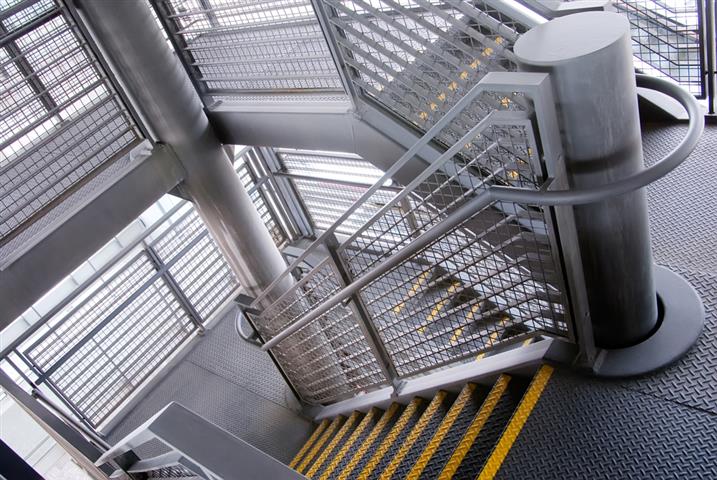 A steel staircase with colour-contrasted nosings provides an example of good stair design. The design would have been even more accessible for people impacted by blindness if colour contrast had been applied to the handrails.